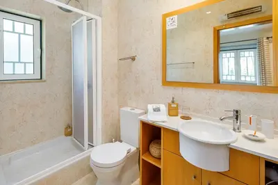 a bathroom with a sink and a toilet and a shower at Falésia Cliff Apartment by The Portuguese Butler in Albufeira