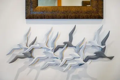a painting on a white wall with a picture at Falésia Cliff Apartment by The Portuguese Butler in Albufeira