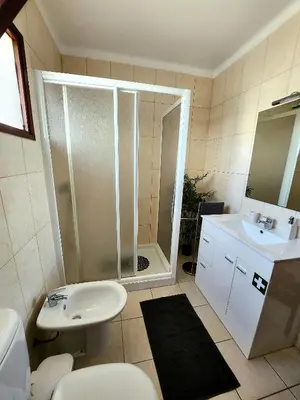 a bathroom with a shower and a toilet and a sink at OceanView Side in Quarteira
