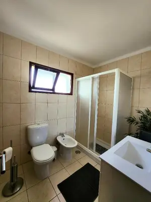 a bathroom with a toilet and a shower and a sink at OceanView Side in Quarteira