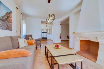 a living room with a couch and a fireplace at Villa Oliveiras de Vilamoura by The Portuguese Butler in Quarteira