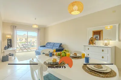 a kitchen and living room with a table with fruit on it at #130 Praia Village by Home Holidays in Vilamoura