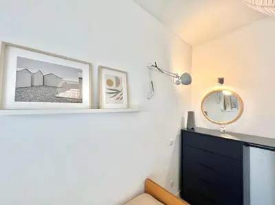 a bedroom with a black dresser and a mirror at Casa Diogo in Faro