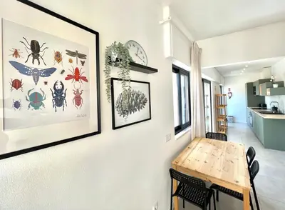 a dining room with a table and pictures on the wall at Casa Diogo in Faro