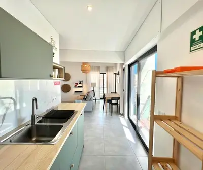 a kitchen with a sink and a counter at Casa Diogo in Faro