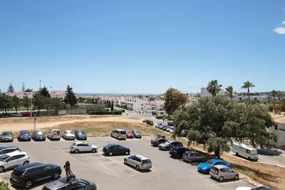 a parking lot with many cars parked in it at Apartment Montechoro in Albufeira