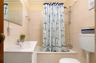 a bathroom with a sink and a shower curtain at Apartment Montechoro in Albufeira