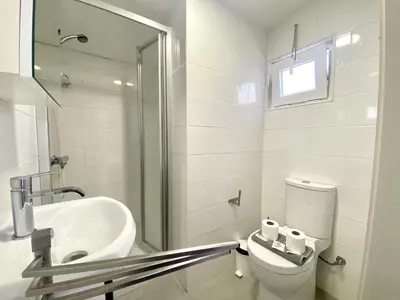 a white bathroom with a toilet and a sink at Quarteira Stylish 2 by Homing in Quarteira