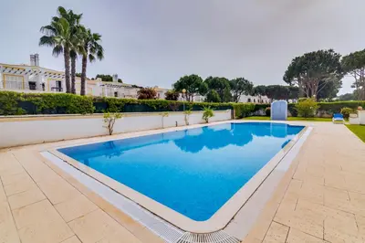 a swimming pool in the middle of a yard at Falésia Nature Villa by The Portuguese Butler in Albufeira
