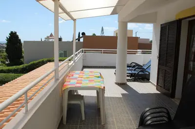 a table on the balcony of a house at ABF18V3 Moradia qualidade e piscina,lindas v in Albufeira