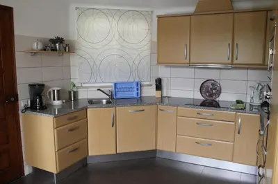 a small kitchen with wooden cabinets and a sink at ABF18V3 Moradia qualidade e piscina,lindas v in Albufeira