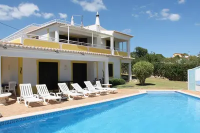 a villa with a swimming pool in front of a house at ABF18V3 Moradia qualidade e piscina,lindas v in Albufeira