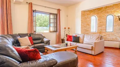 a living room with a couch and a fireplace at Villa Royal Sandals by Algarve Vacation in Albufeira