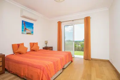 a bedroom with a bed and a large window at ABF36V2 Charming 2 bdr villa located only a few mi in Albufeira
