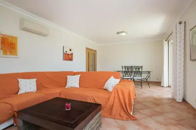 a living room with an orange couch and a table at ABF36V2 Charming 2 bdr villa located only a few mi in Albufeira