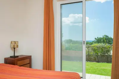 a bedroom with a bed and a sliding glass door at ABF36V2 Charming 2 bdr villa located only a few mi in Albufeira