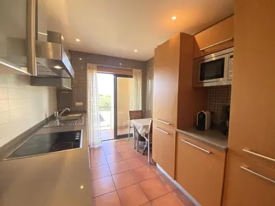 a kitchen with a sink and a table in it at Albufeira Sunny Style With Pool by Homing in Albufeira