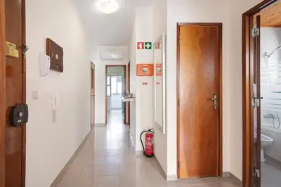 a hallway with a hallway leading to a bathroom at Matinhos House in Faro