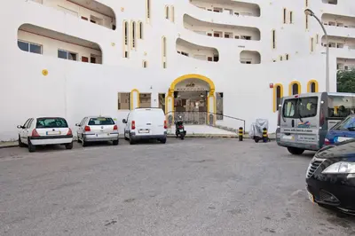 a group of cars parked in front of a building at Green 104 in Albufeira