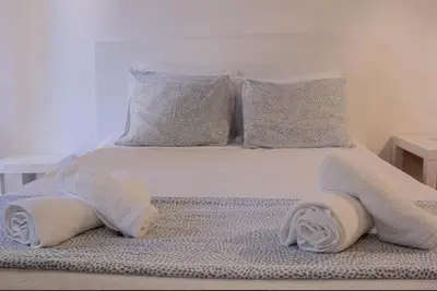 a bed with towels and pillows on it at Green 104 in Albufeira