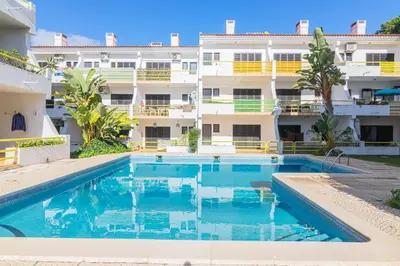 a swimming pool in front of a building at Vilamoura - MAGNÓLIA 512 - T1 in Vilamoura