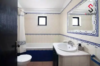 a bathroom with a sink and a tub and a toilet at Villa Tigonema in Albufeira