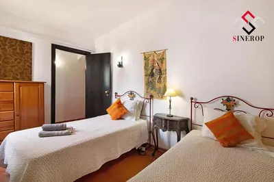 a bedroom with two beds and a dresser at Villa Tigonema in Albufeira