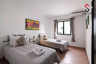 a bedroom with two beds and a window at Villa Tigonema in Albufeira