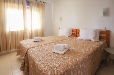 two beds in a hotel room with towels on them at Apart 2 VelaMar - BY BEDZY in Albufeira