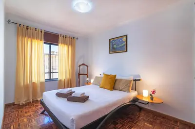 a bedroom with a bed with towels on it at Quarteira CONDESTÁVEL T3 in Quarteira