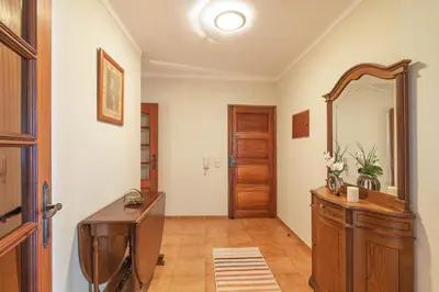 a bathroom with a mirror and a wooden dresser at Quarteira CONDESTÁVEL T3 in Quarteira