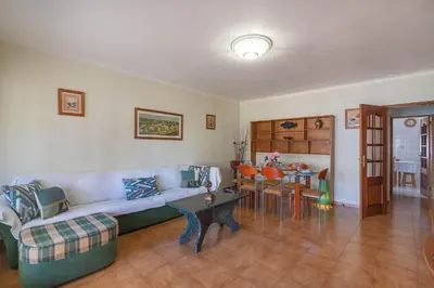 a living room with a couch and a table at Quarteira CONDESTÁVEL T3 in Quarteira