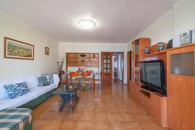 a living room with a couch and a tv at Quarteira CONDESTÁVEL T3 in Quarteira