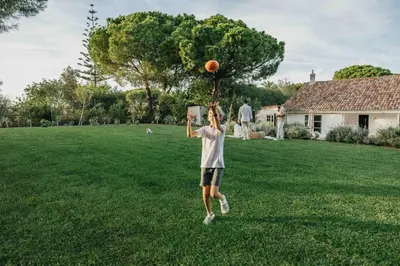 a young man playing with a basketball on a field at Casalot Almancil in Almancil