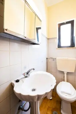 a bathroom with a white sink and a toilet at Villa Camila - Ideal location ten-min walk to Albufeira Marina in Albufeira