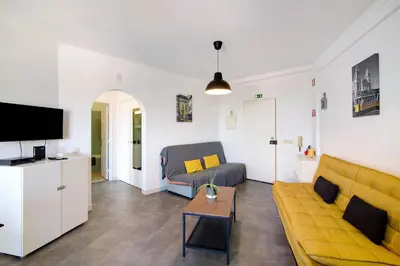 a kitchen with white cabinets and a clock on the wall at T1 Marques in Albufeira