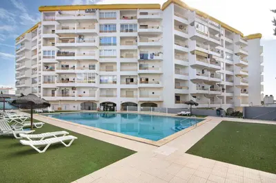 a large apartment building with a large swimming pool at T1 Marques in Albufeira
