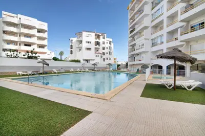 a swimming pool in the middle of a building at T1 Marques in Albufeira