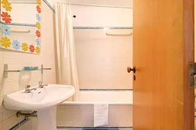 a bathroom with a sink and a bath tub at Apartamento T1 Antonio Henriques in Albufeira