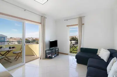 a living room with a couch and a tv at T2 Tubio in Albufeira