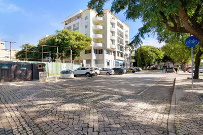 a street with cars parked on the side of a building at T2 Tubio in Albufeira