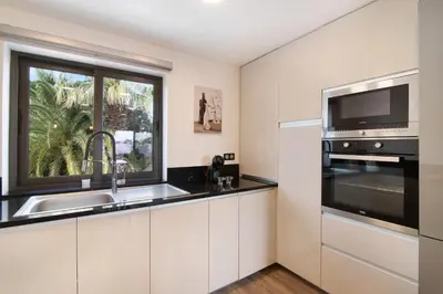 a kitchen with a sink and a window at Flat 2 Bedrooms Cunha in Albufeira