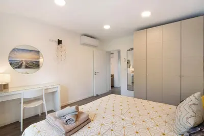 a bedroom with a bed and a desk in a room at Flat 2 Bedrooms Cunha in Albufeira