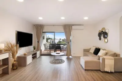 a living room with a couch and a tv at Flat 2 Bedrooms Cunha in Albufeira