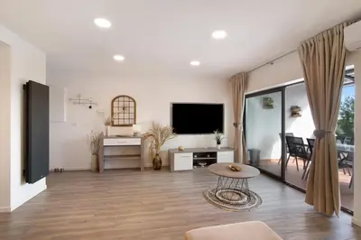 a living room with a television and a table at Flat 2 Bedrooms Cunha in Albufeira