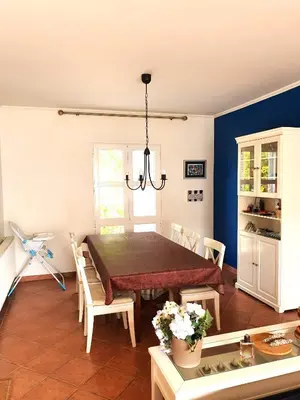 a dining room with a table and chairs at Praia da Galé, 250m da Praia e Piscina in Galé