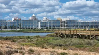a bridge over a river with buildings in the background at Praia da Galé, 250m da Praia e Piscina in Galé