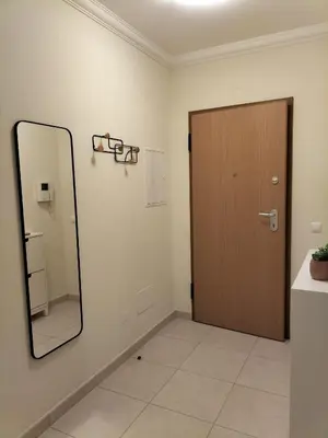 a mirror on a wall next to a door at T2 Infante Moderno Wi-Fi Garagem 50 M Praia in Quarteira