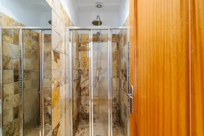 a shower with a glass door in a bathroom at Villa Sea, Sun and Golf in Vilamoura in Quarteira