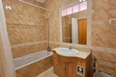 a bathroom with a sink and a bath tub at D'Água Brisa beachside apartment in Albufeira